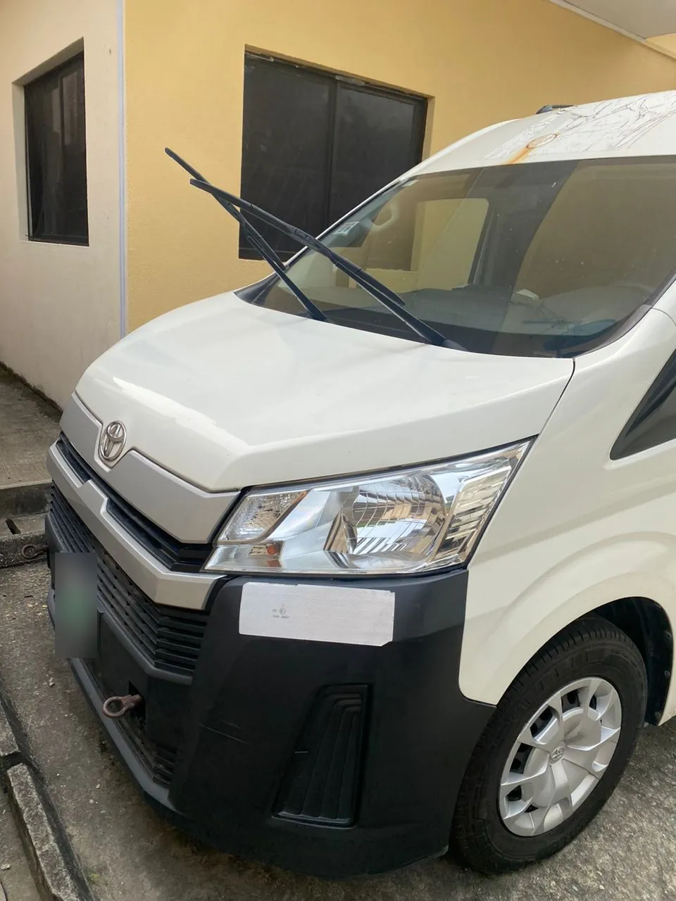 New-model Toyota Hiace bus, front three-quarter view with Toyota badge