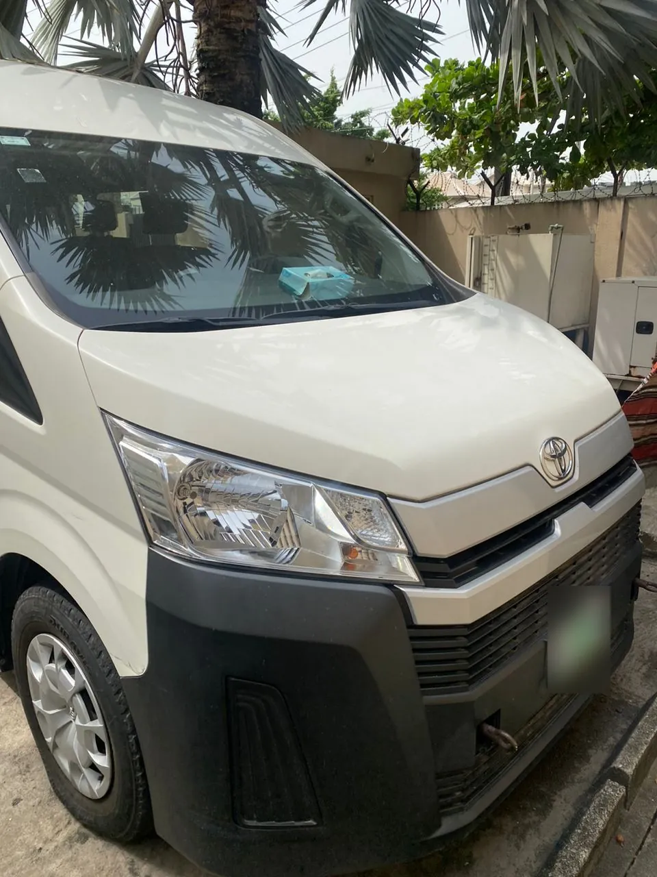 New-model white Toyota Hiace bus, front view, for hire in Lagos